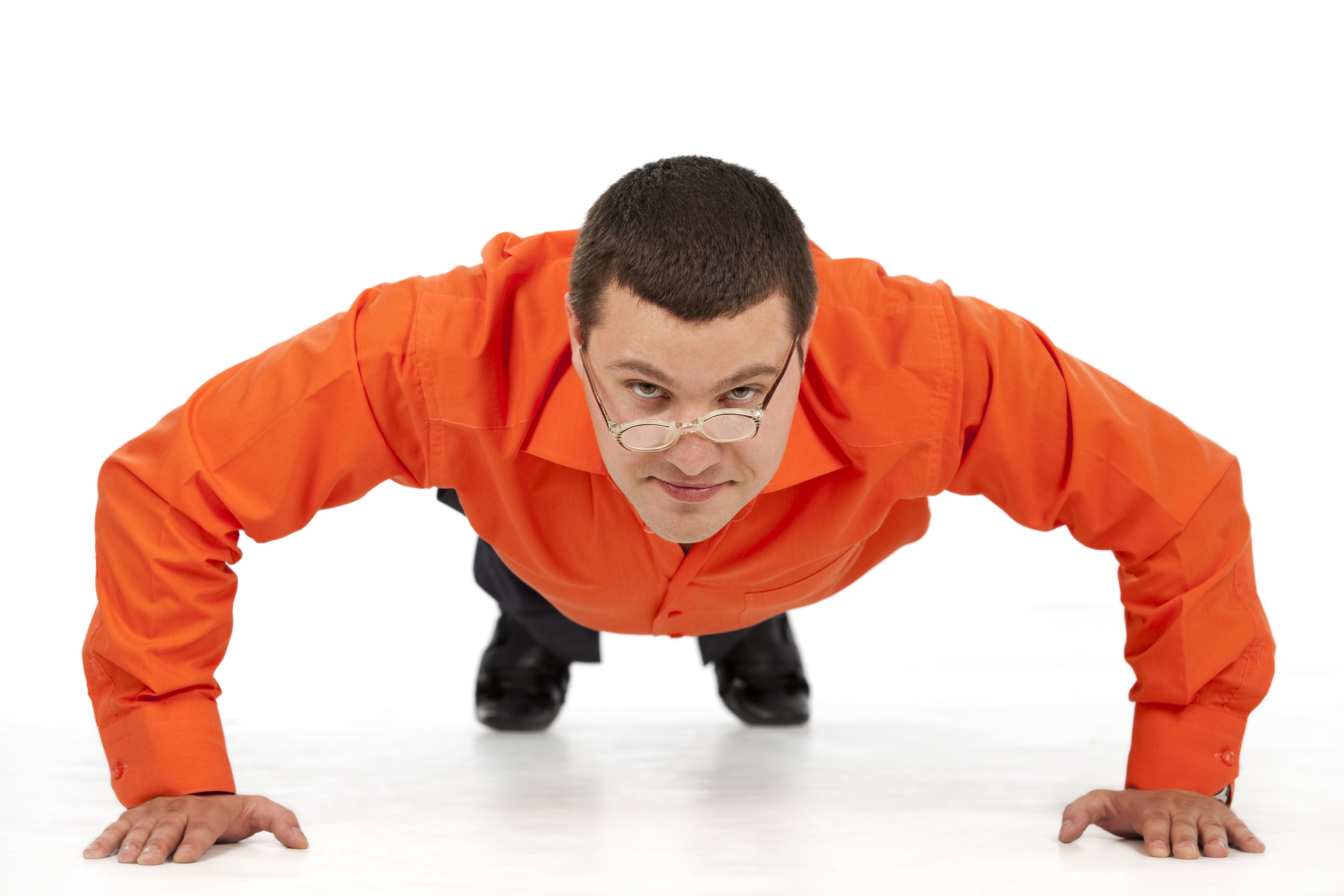 Man in an orange shirt, in a pushup stance