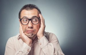 Man with a concerned/embarrassed face